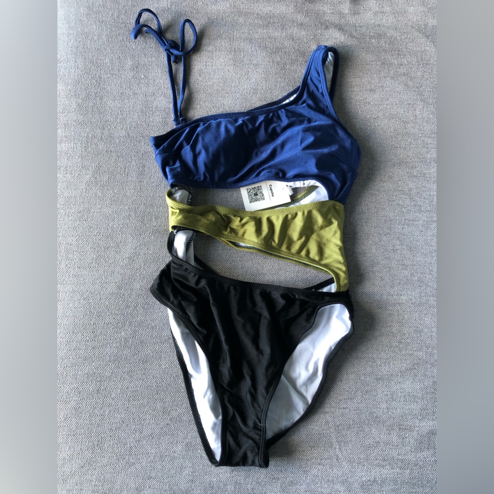 NWT, still in original packaging. One piece swimsuit with cutouts